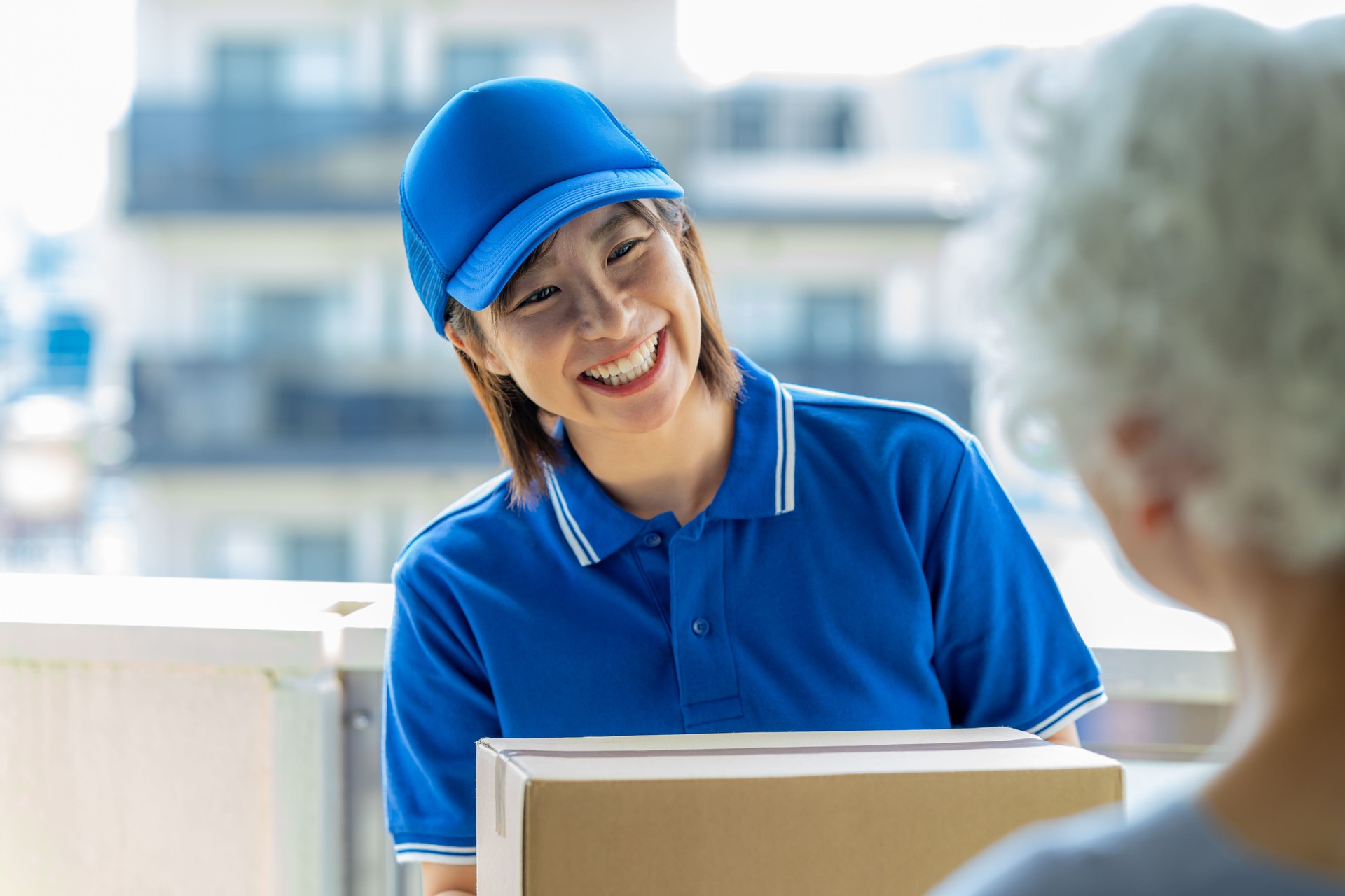 Female courier driver delivering luggage