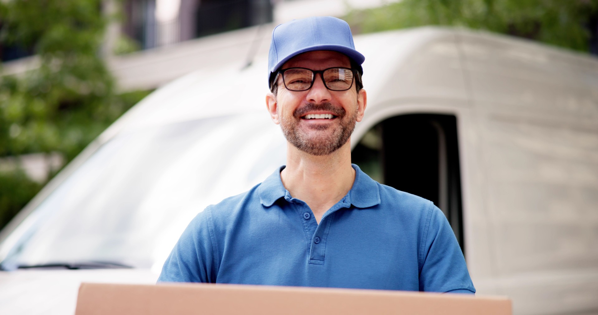 Cheerful Professional Delivery Man Transporting Cardboard Boxes: Representing